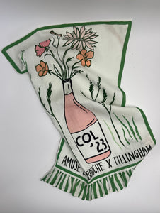 Decorative towel with a bottle and floral design on a white background